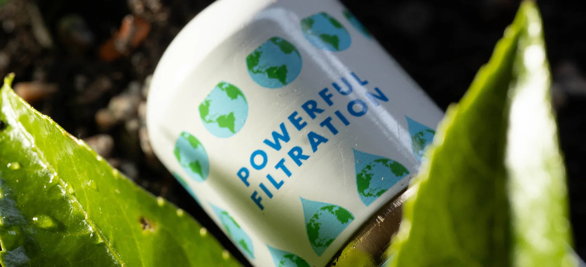 GOpure Pod portable water purifier displayed among fresh green leaves outdoors