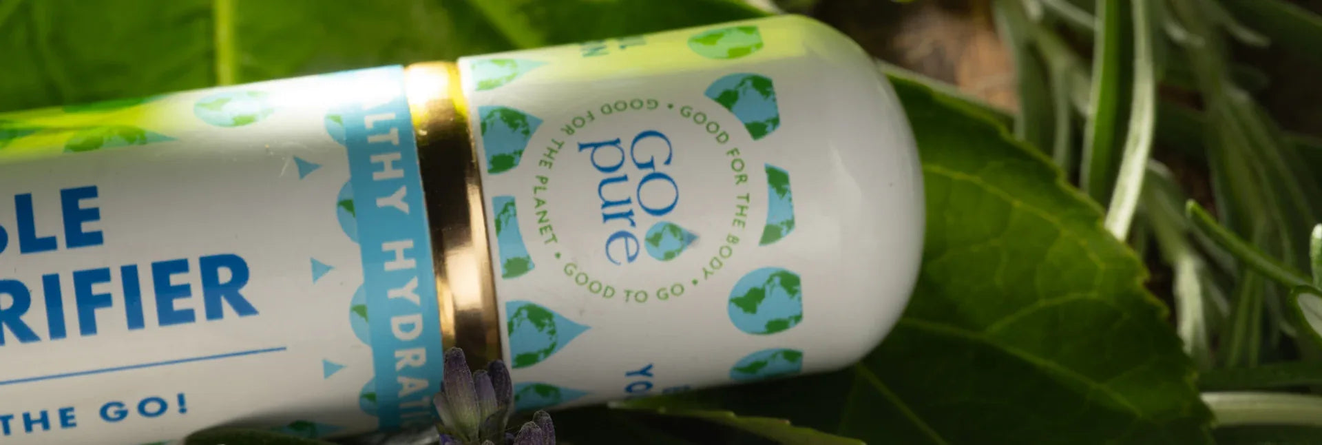 Close-up of GOpure portable water purifier with branding and natural background.